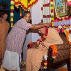 Caitanya Dasa Offers a Garland to Guru Maharaja