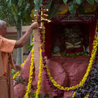 Guru Maharaja offering arati to Giriraja